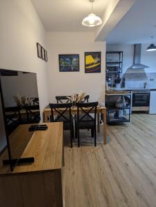 a kitchen and dining room with a table and chairs at Bryngwalia Fach in Cribyn