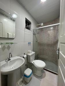 a bathroom with a sink and a toilet and a shower at Pousada Recanto da Ana Alice in Abraão