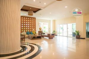 a lobby of a hotel with a couch and a table at Patong Coco Apartment in Patong Beach