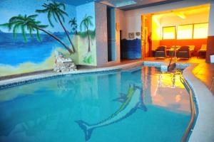 a large swimming pool with dolphins in the water at Pensiunea Milexim in Câmpia Turzii