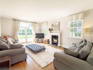 a living room with two couches and a fireplace at The White House - Bordon in Bordon