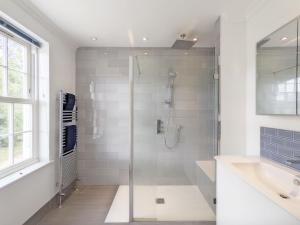 a bathroom with a glass shower and a sink at The White House - Bordon in Bordon
