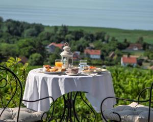 a table with plates of food on top of a field at Maison Bagatell Badacsony in Badacsonytomaj +60 photos