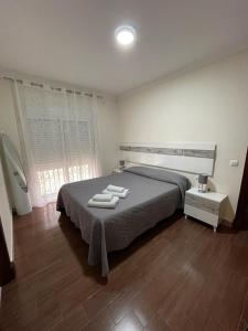 een slaapkamer met een bed met handdoeken erop bij MARIÑIGUEZ APARTAMENT. in Jerez de la Frontera