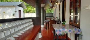 a restaurant with a table and a bench and tables at Marari Casa Almare in Mararikulam +124 photos