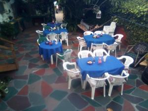 a group of blue tables and chairs on a patio at Zoete Inval in Hermanus