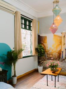 a living room with a table and a window at Hanoi Hola House in Hanoi