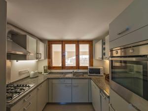 a kitchen with a sink and a stove top oven at The Arches Holiday Home in Kerċem