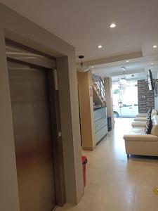 a living room with a door and a couch at HOTEL ALFONSO UGARTE in Chiclayo +6 photos