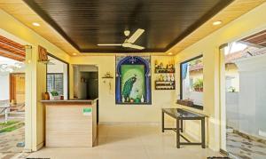 a kitchen with a ceiling fan and a counter at Itsy By Treebo - Morjim Pride in Morjim