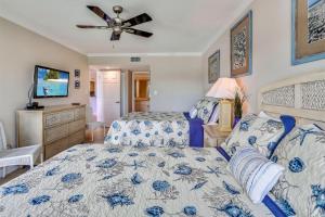 a bedroom with two beds and a ceiling fan at Land's End 4-303 Bay Front - Premier in St Pete Beach +53 photos