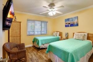 a bedroom with two beds and a ceiling fan at Land's End 6-303 Beach Front - Premier in St Pete Beach