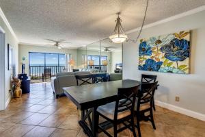 a dining room and living room with a table and chairs at Land's End 9-404 Beach Front - Premier in St. Pete Beach