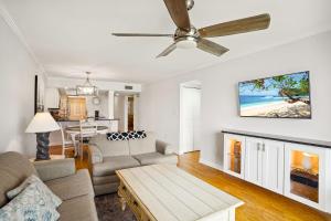 a living room with a couch and a ceiling fan at Land's End 5-204 Gulf-Bay Front - Premier in St. Pete Beach