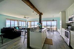 a kitchen and living room with a view of the ocean at Land's End 7-401 Beach Front - Premier in St. Pete Beach