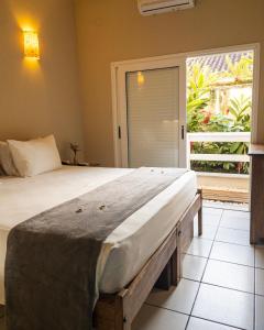 Cama ou camas em um quarto em Pousada Toca da Praia