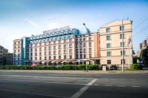 a large building with a sign on top of it at Mercure Riga Centre in Rīga
