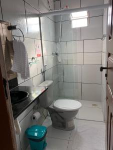 a small bathroom with a toilet and a sink at Pousada Meu Xodó in Barreirinhas