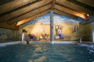 a room with a large painting on the wall at Posada Los Condestables Hotel & Spa in Villalpando