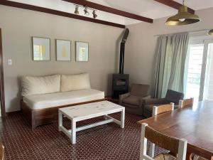 a living room with a couch and a table at La Elina in Villa General Belgrano