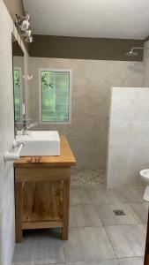a bathroom with a sink and a mirror at La Elina in Villa General Belgrano