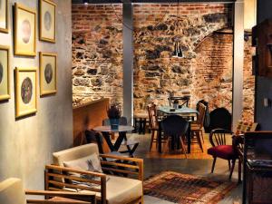 a restaurant with tables and chairs and a brick wall at Hammamhane in Istanbul