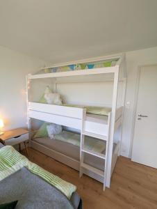a white bunk bed in a room at Ferienwohnung BergOase mit Pool & Sauna in Scheidegg +52 photos
