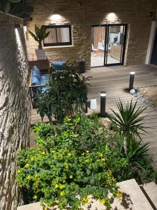 a patio with flowers and plants on a wooden deck at La suite provençale in Marseille