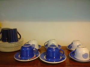a group of blue and white cups and saucers on a table at Residence Solemare in Búzios
