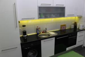 a kitchen with a sink and a washing machine at my happy place in Vienna