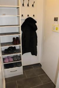 a closet with a black coat hanging on the wall at my happy place in Vienna