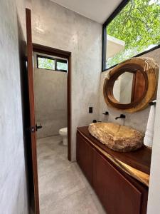 a bathroom with a wooden sink and a mirror at Casa Árabe in Cenote Azul