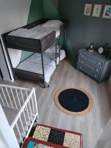 a room with two bunk beds and a table at L'Autre Maison in Lucet