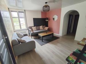 a living room with a couch and a table at L'Autre Maison in Lucet
