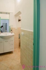 a bathroom with a sink and a shower with a mirror at Borgo Cocconi 33 in Parma