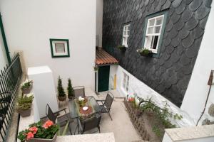 a balcony of a house with a table and chairs at CASA DA AVÓ ZIRINHA in Viseu