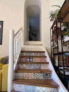 a staircase with tiles on it with a mirror at The Old Stairs in Sofia