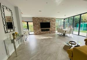 a living room with a fireplace and a dining room at Stunning 5 bed house in Surrey Minimum stay 5 nights in Sunbury