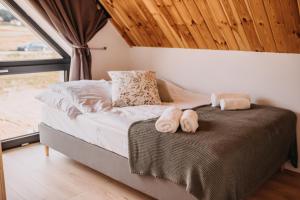 a bedroom with a bed with towels on it at Lasosfera Lasówka in Lasowka