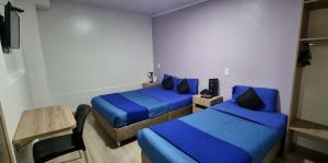 Postel nebo postele na pokoji v ubytování Blue House Corferias