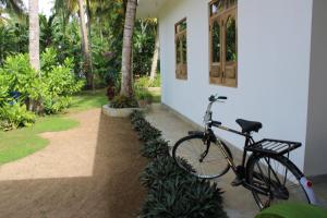 a bike parked in front of a house at Swallow villa - French guest house-ADULTS ONLY in Ahangama