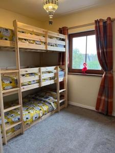 a bedroom with two bunk beds and a window at Lovely 2 bedroom family apartment in Newcastle in Newcastle