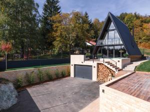 a house with a black roof and a garage at V house Goc 