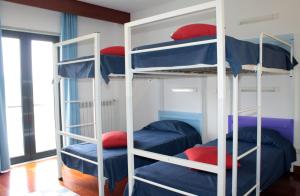 a bunk bed room with three bunk beds in it at HI Alijo - Pousada de Juventude in Alijó