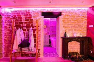 a room with a brick wall and a fireplace at "Glamappartspa" So cosy Champagne offert & Parking in Dijon