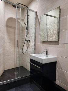 a bathroom with a sink and a shower at Morny Belvédère in Deauville
