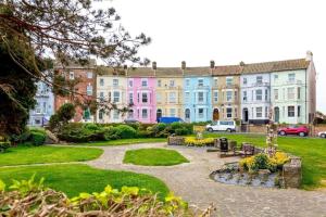 a row of colorful houses in a park at Lovely 1 bed flat 200 metres from beach in Walton-on-the-Naze