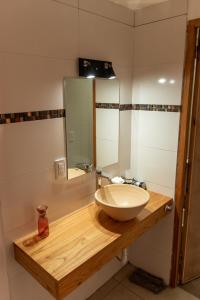 a bathroom with a sink and a mirror at Cabañas Marjumi in Mar de las Pampas