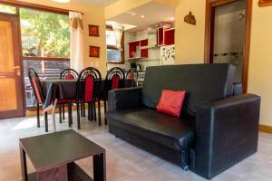 a living room with a couch and a table and chairs at Cabañas Marjumi in Mar de las Pampas