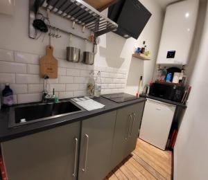a kitchen with a sink and a counter top at Morny Belvédère in Deauville